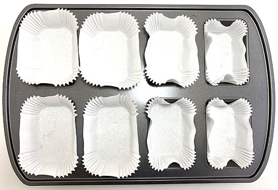Pan that can hold eight mini loaves is filled with liners.