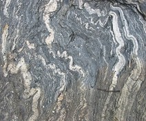  metamorphic rock with warped, squiggly layers 