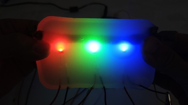 sheet of silicone rubber with embedded red, green, and blue LEDs