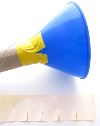 A plastic funnel is inserted into a cardboard tube and secured with tape