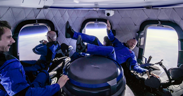 Weightless in space, I shoot a video of the earth on my wrist-mounted GoPro (at Seat 1), while crewmate Sylvain (Seat 3) floats through the cabin