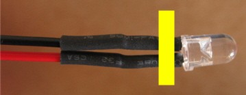 Heat shrink tubing secures wires attached to the leads of an LED
