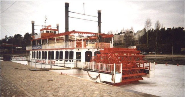 a paddle boat docked in a rive