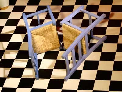 Two chairs placed on their sides with a small gap between the front edge of each seat