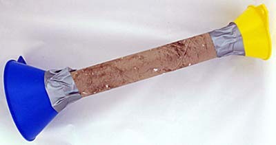 Two plastic funnels are taped into opposite ends of a cardboard tube