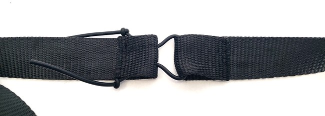 Knots tied in both ends of the rubber cord near the strap to keep the cord from pulling through the holes 