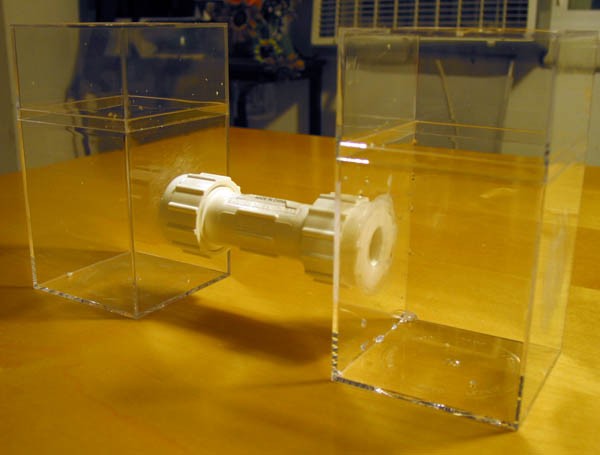 homemade Microbial fuel cell - A plastic tube connects two plastic containers