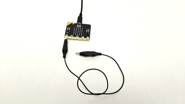 microbit with alligator clip connected to pin 0 and other end free