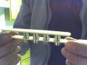 Two popsicle sticks are glued together with four magnets inbetween