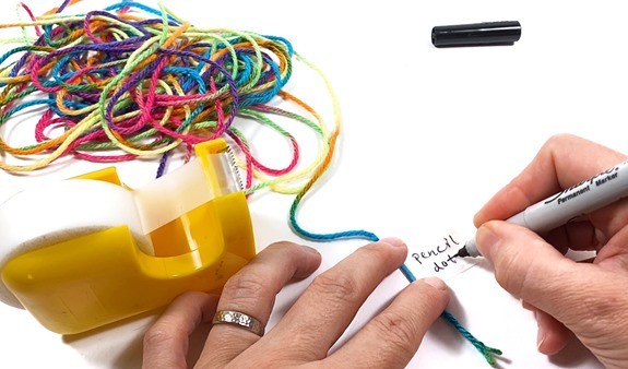A 10-meter long piece of string with an attached label that says 'pencil dot'