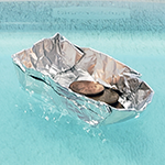 Aluminum foil boat for an experiment exploring how much weight a boat can hold and stay afloat