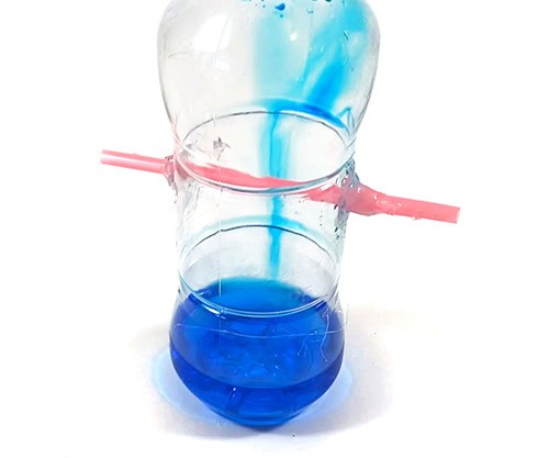 Plastic bottle with some colored water inside.
