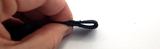 The casing forms a loop at the end of the strap. 