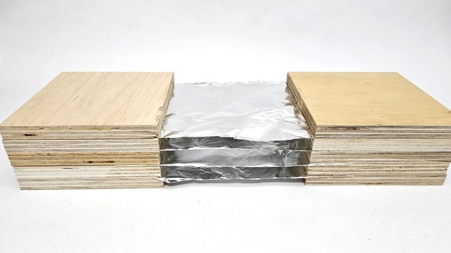 A four-layer model Whipple shield made with plywood and aluminum foil