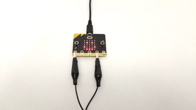 microbit with alligator clip connected to pins 0 and 3V