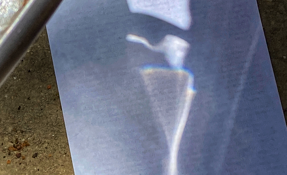 Rainbow created from light shining through a container of water onto paper