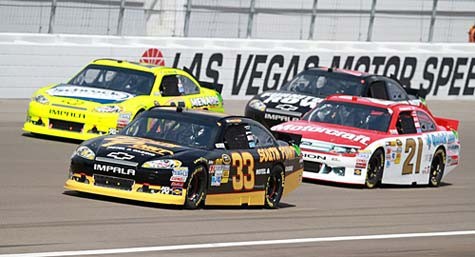 NASCAR cars racing on a track