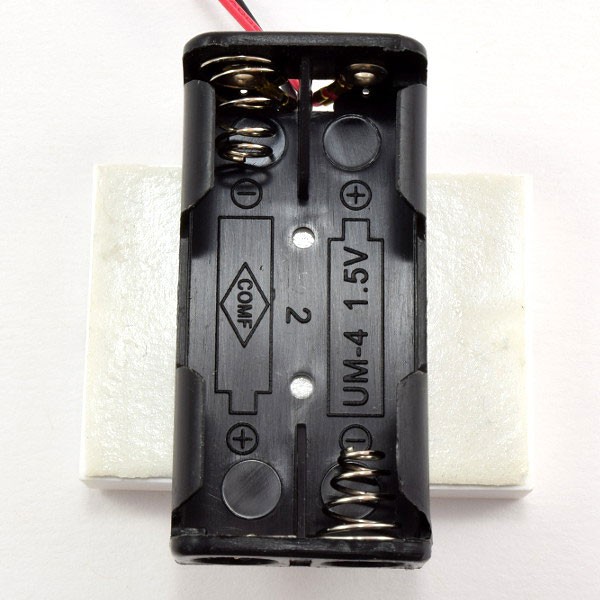 Mount the battery holder to the sticky tape 