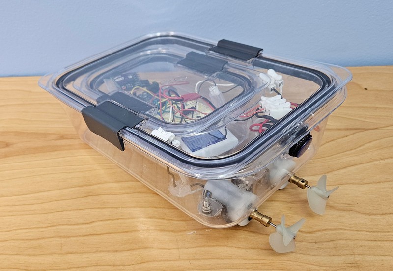 Arduino circuit inside double-hulled boat made from two plastic food storage containers