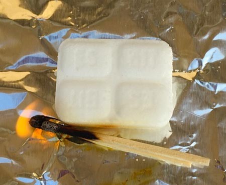 Light the fuel tablet with a match 